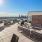 a deck with chairs and tables overlooking a city